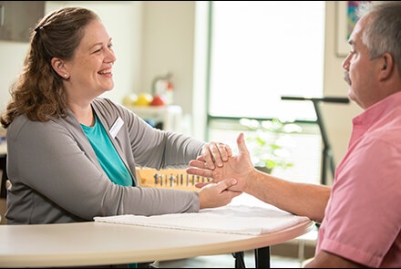Therapist working with patient's hands